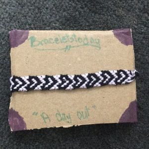 A heart styled bracelet made of cotton string.